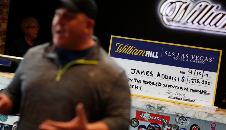James Adducci speaks with the media in front of a novelty check after winning more than one million dollars betting on Tiger Woods winning the Masters, Monday, April 15, 2019, in Las Vegas.