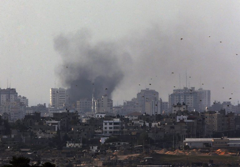 Birds fly as a plume of smoke is seen over central Gaza Strip, after an airstrike by Israeli forces, as seen from the Israel Gaza border, Monday, Nov. 19, 2012. Israeli aircraft struck crowded areas in the Gaza Strip and killed a senior militant with a missile strike on a media center Monday, driving up the Palestinian death toll to 96, as Israel broadened its targets in the 6-day-old offensive meant to quell Hamas rocket fire on Israel. (AP Photo/Lefteris Pitarakis)