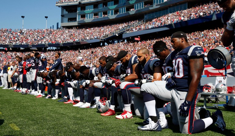 Several NFL players kneel during the national anthem before a football game on Sunday. On Friday, President Trump addressed the ongoing protests where some NFL players take a knee during the national anthem. (AP Photo/Michael Dwyer)