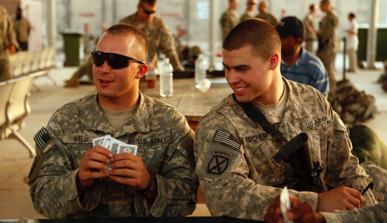 U.S. Army soldiers from 2nd Brigade, 10th Mountain Division, play cards as they wait at Baghdad International Airport to begin their journey to the United States. The soldiers, based at Fort Drum, N.Y., are headed home after nine months in Iraq as part of the U.S. drawdown of forces, which begins in earnest next month. The number of soldiers in Iraq is expected to go from 77,500 currently in the country to 50,000 by September 1. 