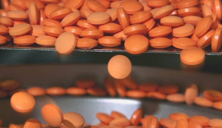 Pills move through a precision weighing machine at the Interphex2006 pharmaceutical manufacturers trade show in New York.