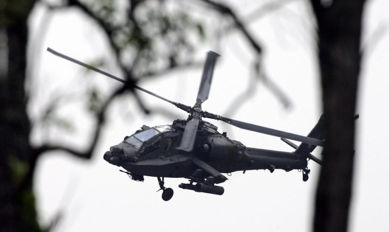 An Apache helicopter practices an attack while communicating with ground troops during a training session at Fort Campbell, Ky.