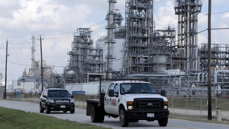 A truck passes a petrochemical plant in Deer Park, Texas.