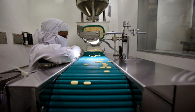 FILE - In this file photo taken Thursday, Feb. 9, 2012, a pharmacist is seen working in a lab where medicines are being produced at a manufacturing unit on the outskirts of Mumbai, India. India's patent office on Monday march 12, 2012  effectively ended Bayer's monopoly on a patented cancer drug by allowing the manufacturing of a generic copy at a fraction of the price.