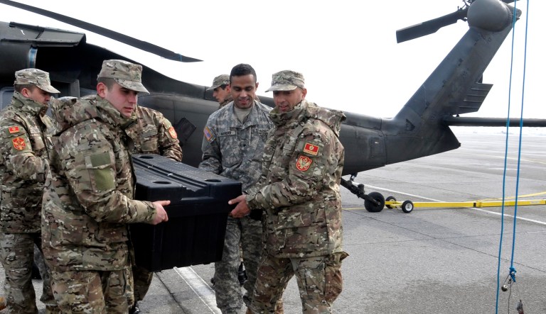 Montenegro and U.S. Army soldiers unloading aid from US helicopters which arrived in Montenegro.  