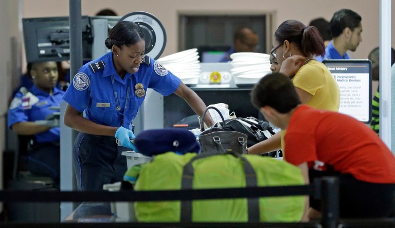 A Transportation Security Administration officer checks travelers luggage to be screened by an x-ray machine at a checkpoint at Fort Lauderdale-Hollywood International Airport, Friday, May 27, 2016, in Fort Lauderdale, Fla. Memorial Day weekend, the unofficial start of summer vacations for many and a busy travel period, serves as a crucial test for the TSA.