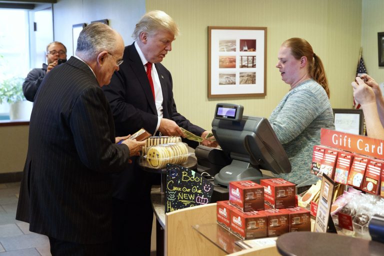 Former New York mayor Rudy Giuliani, left, stands with Republican presidential candidate Donald Trump as he pays for cookies during a visit to Eat'n Park restaurant, Monday, Oct. 10, 2016, in Moon Township, Pa.