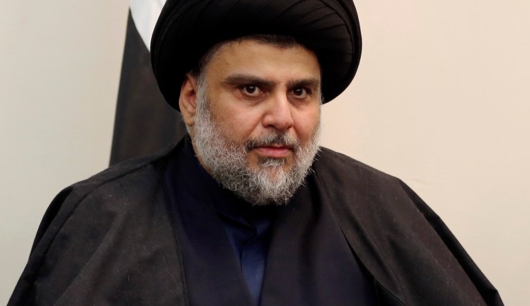 Influential Iraqi Shiite cleric Muqtada al-Sadr sits with Iraqi Christians during a visit to Our Lady of Salvation Church, in Baghdad, Iraq, Monday, Dec. 26, 2016.