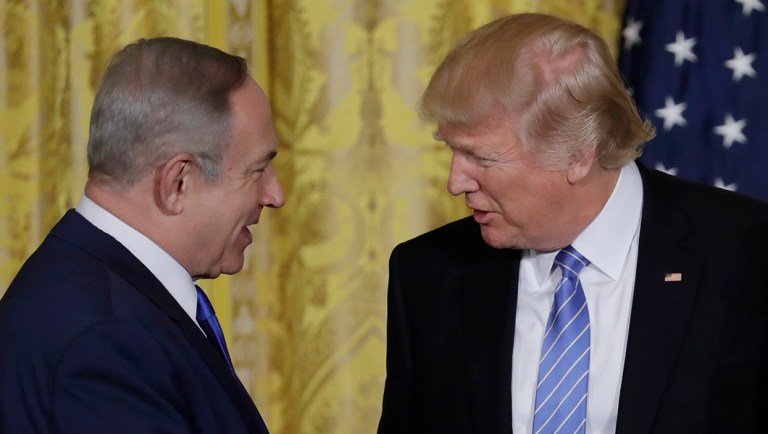 President Trump and Israeli Prime Minister Benjamin Netanyahu shake hands.