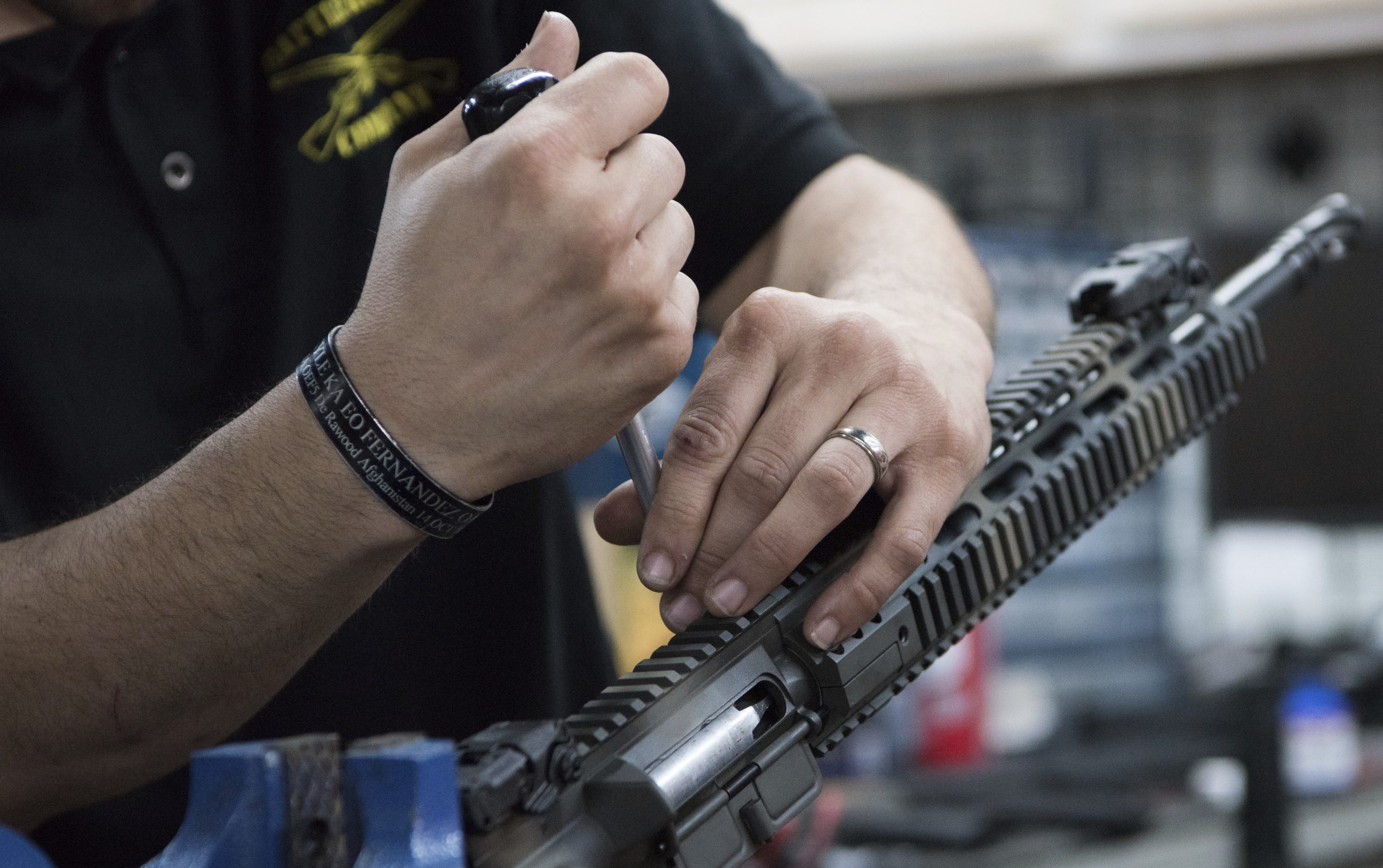 In this photo taken March 15, 2017, Karl Sorken, production manager for Battle Rifle Co., based in Webster, Texas, works on the rails of an AR-15 style rifle.
