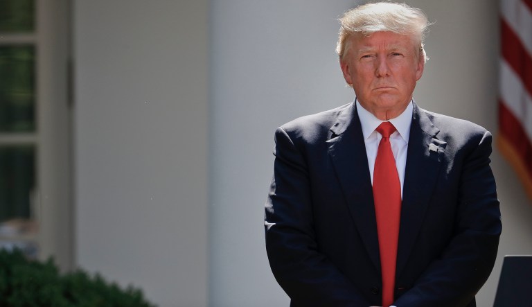 President Donald Trump stands next to the podium after speaking about the U.S. role in the Paris climate change accord, Thursday, June 1, 2017, in the Rose Garden of the White House in Washington.