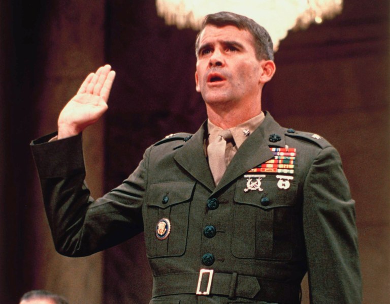 In this July 7, 1987, file photo, Lt. Col. Oliver North is sworn in before the Iran Contra Committee prior to his testimony in Washington. He now heads the NRA and is continuing his call for patriotism, this time to protesting sports figures.