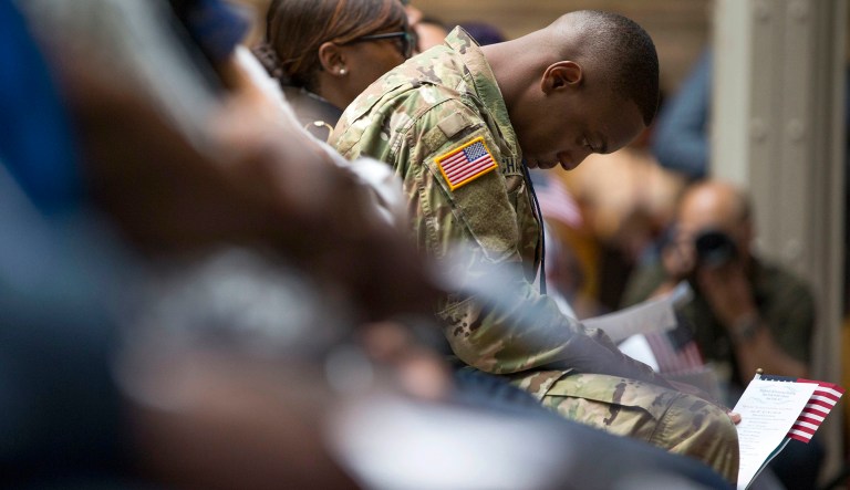 U.S. Army Specialist Shane Cardel, of Jamaica, bows his head after taking the Naturalization Oath of Allegiance in New York on June 30, 2017.