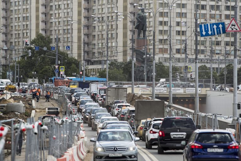 Cars move amid reconstruction works, with a monument to Lenin in the back, in Moscow, Russia, Wednesday, July 5, 2017. The Russian capital has undergone a massive reconstruction effort that paralyzed traffic in some sections of the city for months. 