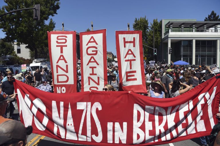 Demonstrators march during a free speech rally Sunday, Aug. 27, 2017, in Berkeley, Calif. Several thousand people converged in Berkeley Sunday for a "Rally Against Hate" in response to a planned right-wing protest that raised concerns of violence and triggered a massive police presence. Several people were arrested for violating rules against covering their faces or carrying items banned by authorities.
