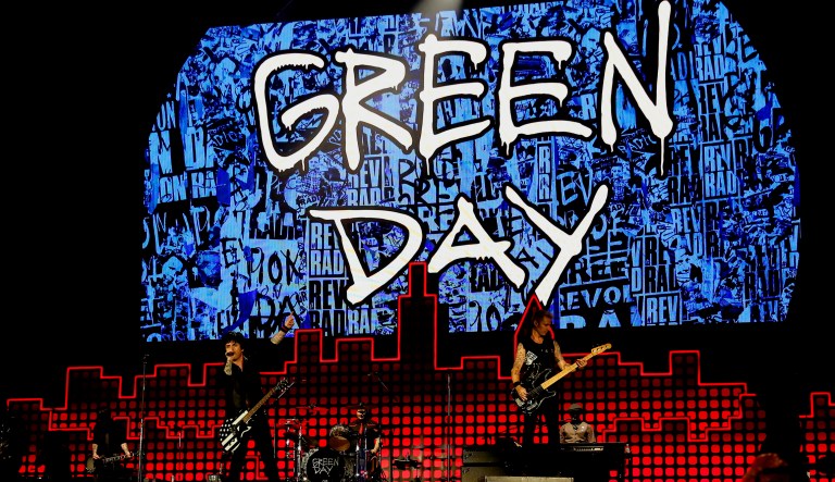 Billie Joe Armstrong (pictured center), Tre Cool and Mike Dirnt of Green Day perform at a concert.
