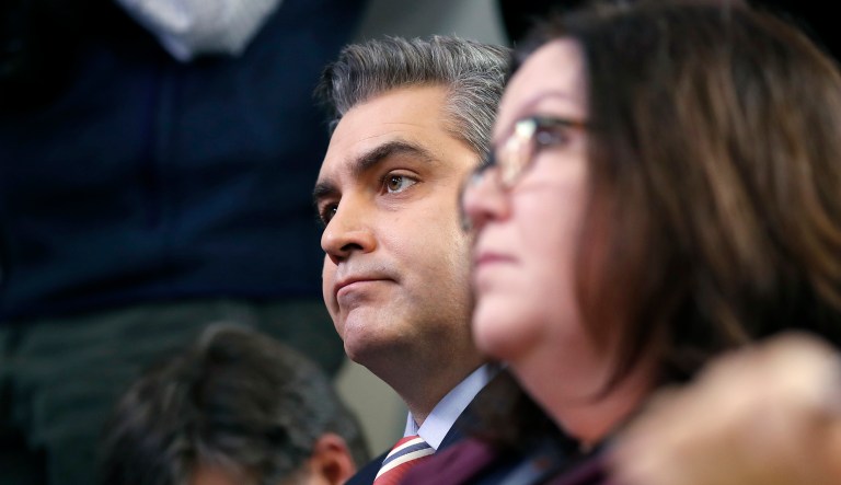 CNN's Jim Acosta listens to White House press secretary Sarah Sanders during a press briefing at the White House, Monday, Dec. 11, 2017, in Washington.