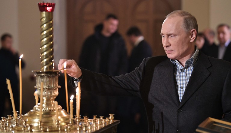 Russian President Vladimir Putin attends a mass at the Church of Sts. Simeon and Anna in his hometown of St. Petersburg, Russia, late Saturday, Jan. 6, 2018. The Russian Orthodox, like several other Orthodox denominations, observes Christmas on January 7.