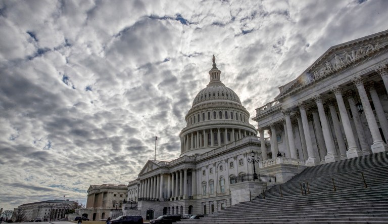 The Capitol is seen under cloudy skies on Day 2 of the federal shutdown, in Washington, Sunday, Jan. 21, 2018.