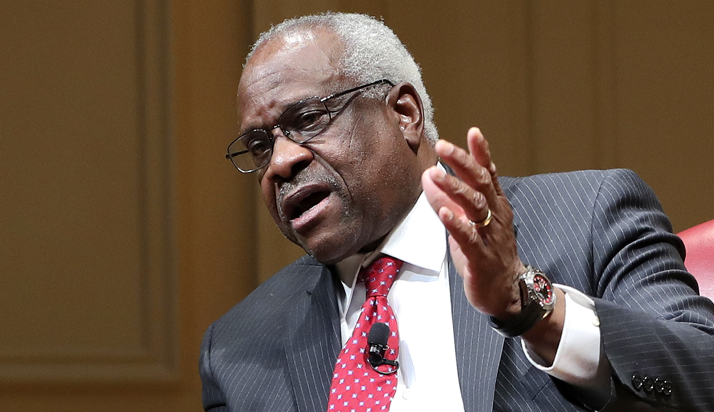 Supreme Court associate justice Clarence Thomas gestures as he speaks during an event.