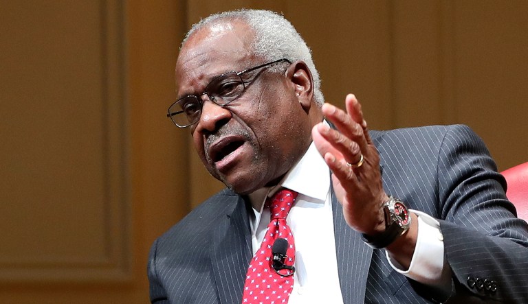 Supreme Court Justice Clarence Thomas gestures as he speaks during an event.