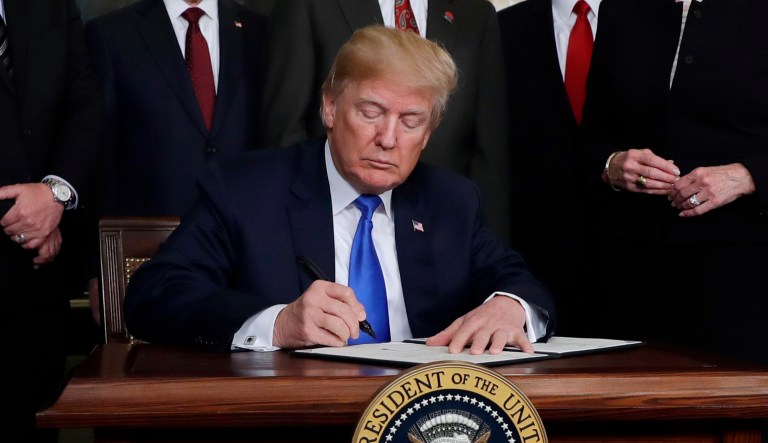 President Trump signs a presidential memorandum imposing tariffs and investment restrictions on China in the Diplomatic Reception Room of the White House, Thursday, March 22, 2018, in Washington. 