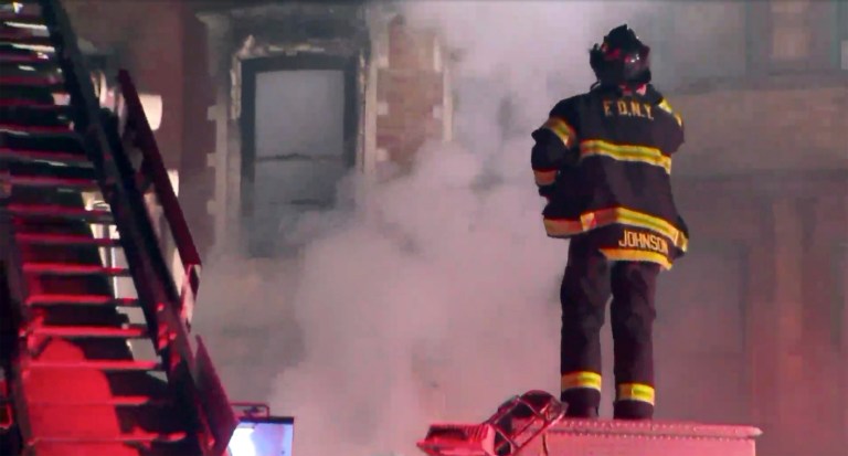 This photo provided by WPIX-11 shows New York Firefighters at the scene of a raging fire.