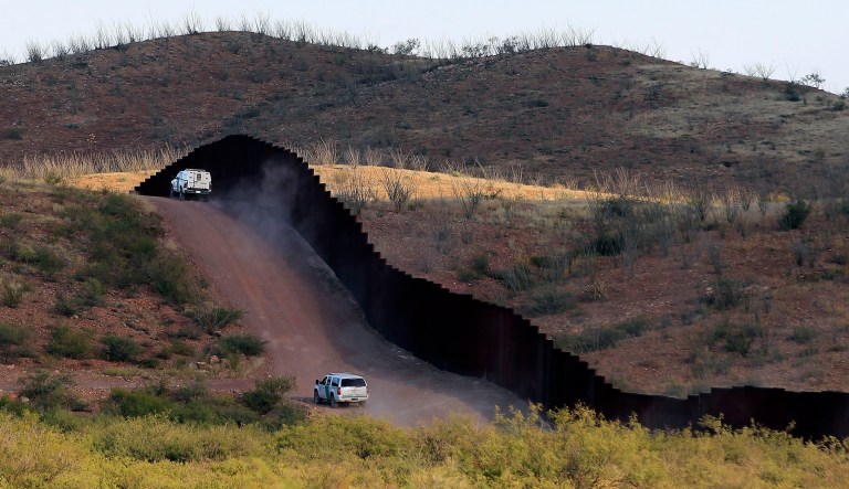 Law enforcement agents patrol the border fence in Naco, Arizona.