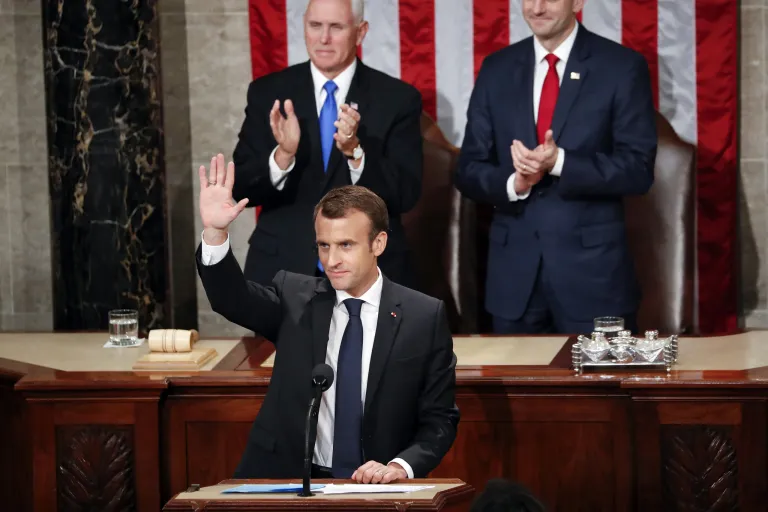 French President Emmanuel Macron waves after speaking to a joint meeting of Congress on Capitol Hill in Washingtonn on Wednesday. Standing behind him are Vice President Mike Pence and House Speaker Paul Ryan, R-Wis.