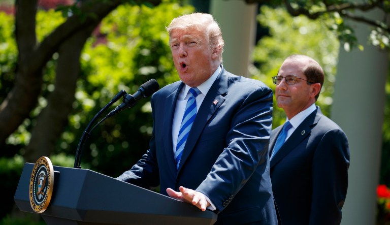 Secretary of Health and Human Services Alex Azar looks on as President Trump speaks during an event about prescription drug prices in the Rose Garden of the White House, May 11, 2018, in Washington.