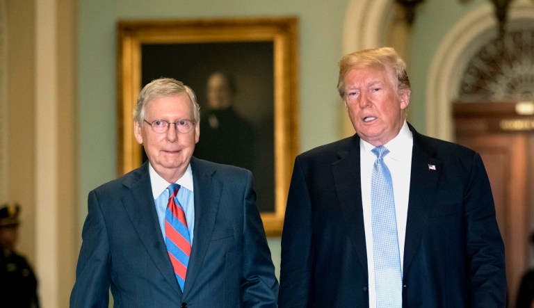 President Trump (right) walks with Senate Majority Leader Mitch McConnell, R-Ky., left, to a closed-door meeting with Senate Republicans at the Capitol in Washington.