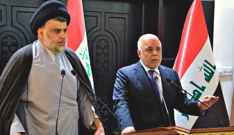 In this photo provided by the Iraqi government, Iraqi Prime Minister Haider al-Abadi, right, and Shiite cleric Muqtada al-Sadr hold a press conference in the heavily fortified Green Zone in Baghdad, Iraq on Sunday. Shiite cleric Muqtada al-Sadr, whose coalition won the largest number of seats in Iraq's parliamentary elections, says the next government will be "inclusive." The May 12 vote did not produce a single bloc with a majority, raising the prospect of weeks or even months of negotiations to agree on a government.
