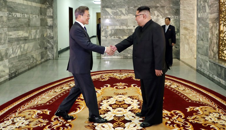 In this May 26, 2018 photo provided on May 27, 2018, by South Korea Presidential Blue House via Yonhap News Agency, North Korean leader Kim Jong Un, right, and South Korean President Moon Jae-in, left, shake hands before their meeting at the northern side of Panmunjom in North Korea. Kim and Moon met Saturday, May 26, for the second time in a month, exchanging a huge bear hug and broad smiles in a surprise summit at a border village to discuss Kim's potential meeting with U.S. President Donald Trump and ways to follow through on the peace initiatives of the rivals' earlier summit. 