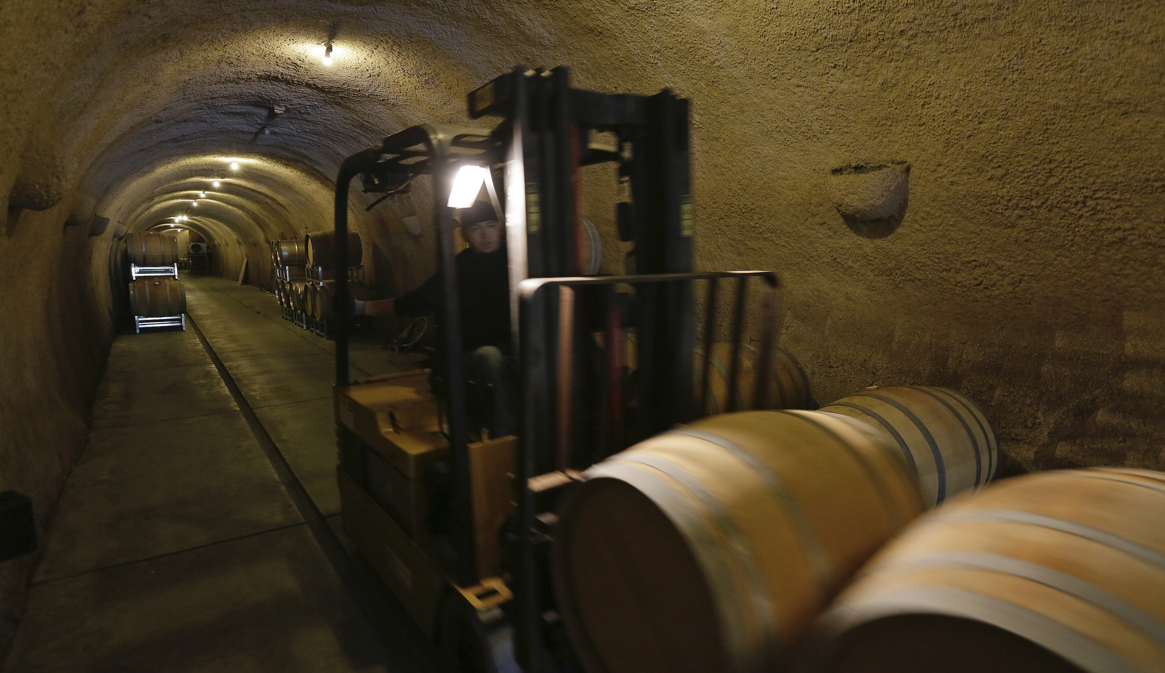 In this photo taken on May 21, 2018, a cellar worker takes barrels into a cave at the Keller Estate winery in Petaluma, California. The winery is located in Northern California's Petaluma Gap which is one of America's newest viticultural areas.