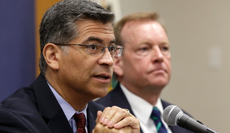 California Attorney General Xavier Becerra, left, flanked by McGregor Scott, right, the United States Attorney for the Eastern District of California, discusses an increase in the use of a banned pesticide at illegal marijuana farms hidden on public lands Tuesday, May 29, 2018, in Sacramento, California. 