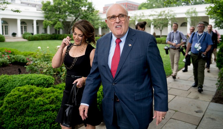 Rudy Giuliani, an attorney for President Donald Trump, center, accompanied by Jennifer Le Blanc, left, arrives for White House Sports and Fitness Day on the South Lawn of the White House, Tuesday, May 29, 2018, in Washington.