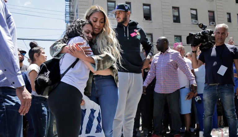 Former New York Knick Carmelo Anthony, third from left, his wife La La Anthony, second from left, and an unidentified woman visit a memorial to Lesandro Guzman-Feliz near the site of his murder in the Bronx borough of New York, Monday, June 25, 2018. Several suspects are in custody in New Jersey and awaiting extradition in connection with last week's killing of the 15-year-old boy in the Bronx that has sparked community outrage. Police said that Guzman-Feliz's death was gang related.