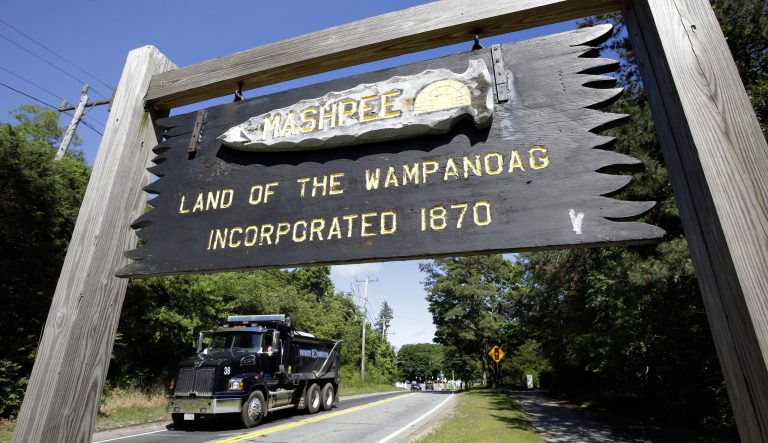 In this Monday, June 25, 2018 photo a wooden sign advises motorists of the location of Mashpee Wampanoag Tribal lands in Massachusetts.