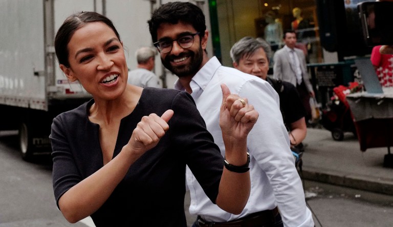 Alexandria Ocasio-Cortez, the winner of a Democratic Congressional primary in New York, greets a passerby in New York, Wednesday, June 27, 2018, the morning after she upset U.S. Rep. Joe Crowley in Tuesday's primary election. 