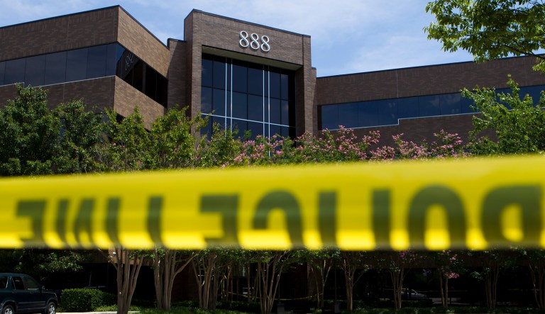 Police tape surrounds the front entrance of the office building housing The Capital Gazette newspaper in Annapolis, Md., on Friday.