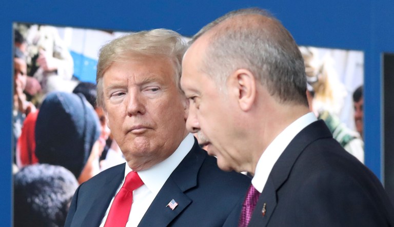 President Trump talks to Turkish President Recep Tayyip Erdogan as they tour the new NATO headquarters in Brussels, Belgium, on July 11, 2018.