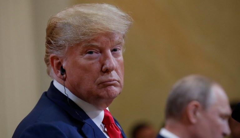President Trump looks over while listening to Russian President Vladimir Putin speak during their joint news conference in Helsinki, Finland, July 16, 2018.