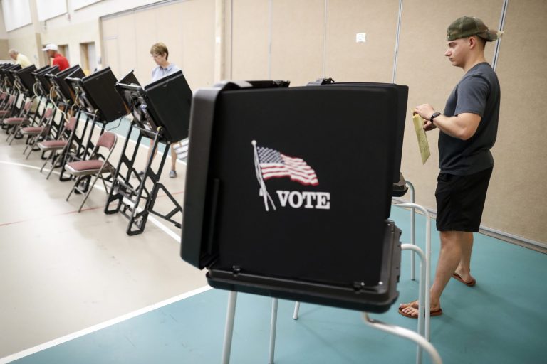 Voters cast their ballots in a polling station at Quest Community Church, Tuesday, Aug. 7, 2018, in Westerville, Ohio.