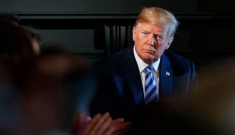 President Trump listens during a meeting with state leaders about prison reform on Aug. 9, 2018, at Trump National Golf Club in Bedminster, N.J. 