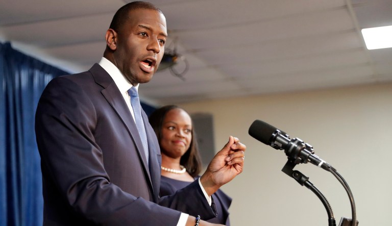 Florida Democratic gubernatorial candidate Andrew Gillum, left, speaks to supporters as his wife R. Jai Gillum listens during a Democratic Party rally Friday, Aug. 31, 2018, in Orlando, Fla. 