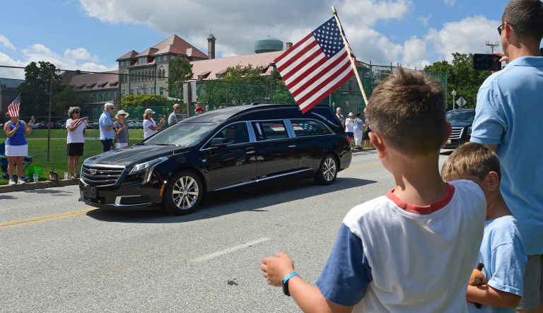 People watch as the casket of Sen. John McCain, R-Ariz., is brought to Annapolis, Md., Sunday, Sept. 2, 2018, for his funeral service and burial at the U.S. Naval Academy. McCain died Aug. 25 from brain cancer at age 81. 