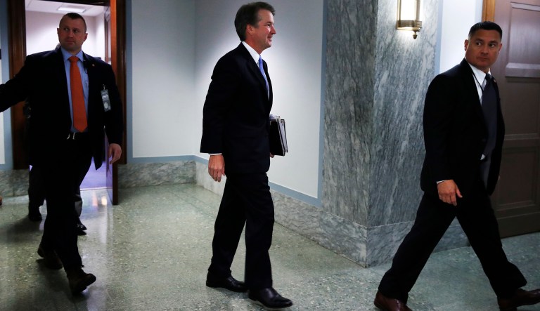 President Donald Trump's Supreme Court nominee, Brett Kavanaugh, center, leaves the hearing room to attend a closed session of the Senate Judiciary Committee after three rounds of questioning on the third day of his confirmation hearing, Thursday, Sept. 6, 2018, on Capitol Hill in Washington, to replace retired Justice Anthony Kennedy.