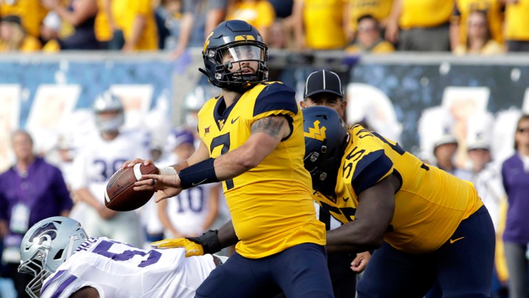 West Virginia quarterback Will Grier (7) throws a pass during the first half of an NCAA college football game against Kansas State in Morgantown, W.Va.