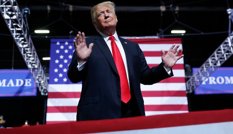 President Donald Trump hold up his hands and rocks back and forth during the playing of John Denver's "Take Me Home, Country Roads" song while on stage at a campaign rally at WesBanco Arena, Saturday, Sept. 29, 2018, in Wheeling, W.Va.