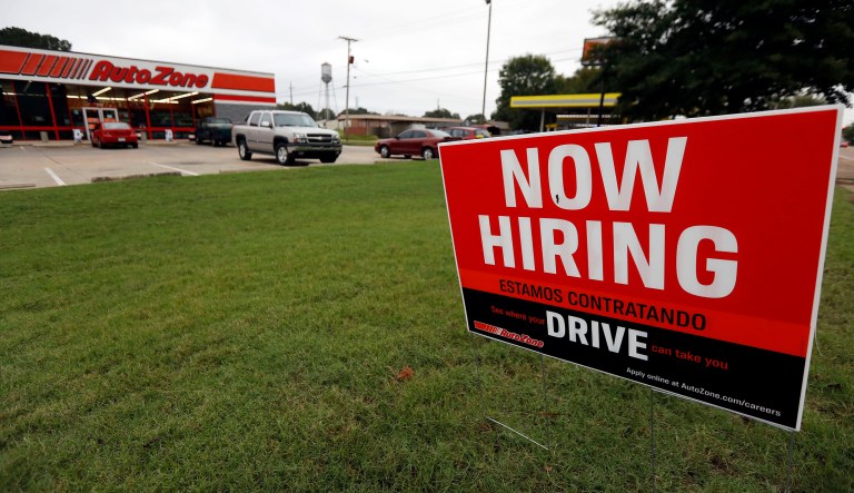 FILE- In this Sept. 27, 2018, file photo a bilingual help wanted sign for Auto Zone, a retailer of aftermarket automotive parts and accessories, is posted outside the store in Canton, Miss. Another healthy picture of hiring is expected when the U.S. government issues its September jobs report Friday, Oct. 5. 